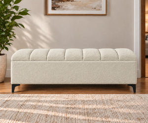 Cream upholstered storage bench with tufted cushion and black legs