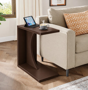 Dark brown C-shaped end table next to living room sofa