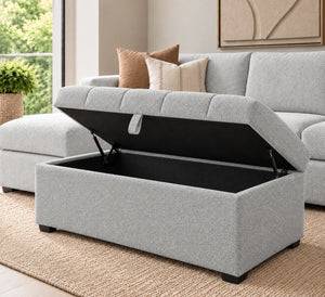 Light grey storage ottoman with open lift-up storage compartment