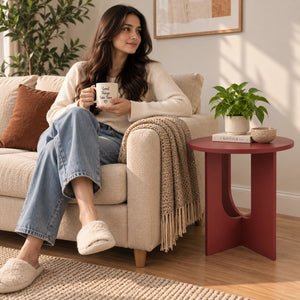 Maroon end table beside lounge chair
