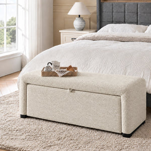 Off-white upholstered storage ottoman bench at the foot of bed