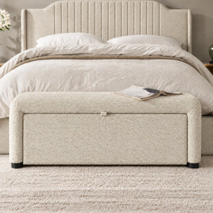 Off-white storage ottoman bench at the foot of a modern bedroom