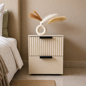 Solid Wood bedside table with fluted drawer design placed beside a modern bed in a contemporary bedroom.