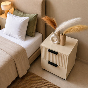 Top angle view of a Solid Wood bedside table with decorative vases placed next to a stylish bed.