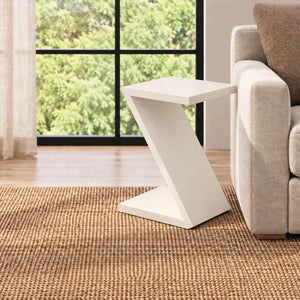 White Z-shaped end table positioned beside a sofa