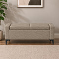 Beige upholstered storage ottoman bench with cushioned top and black legs