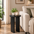 Black round end table beside sofa