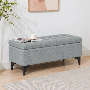blue grey upholstered storage bench with black legs
