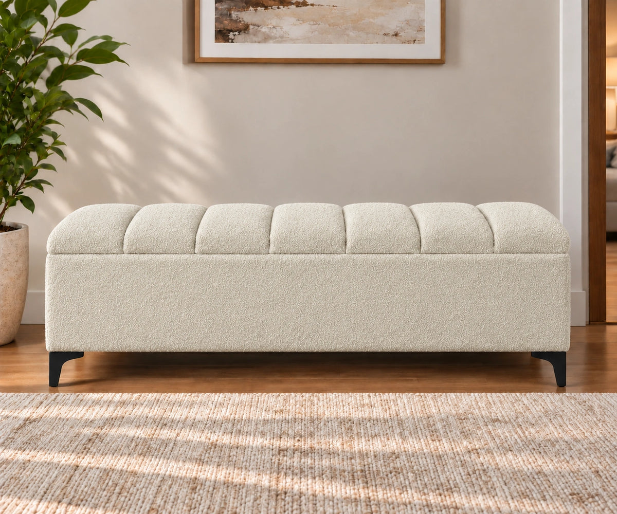 Cream upholstered storage bench with tufted cushion and black legs