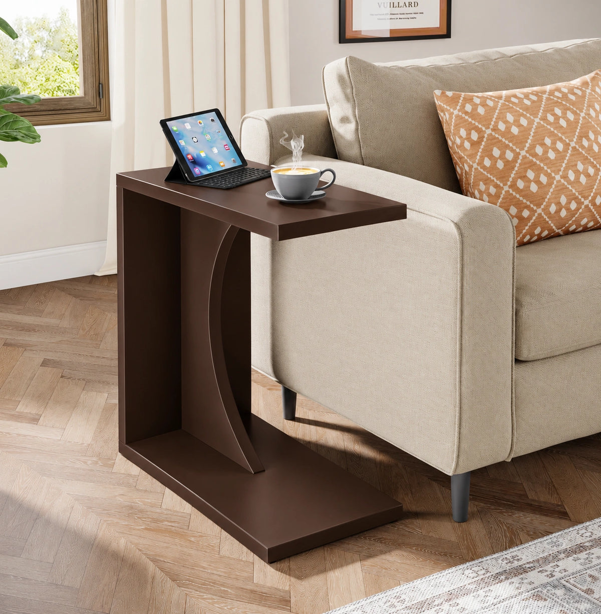 Dark brown C-shaped end table next to living room sofa