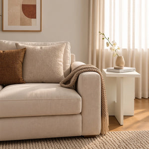 Elara white end table beside sofa