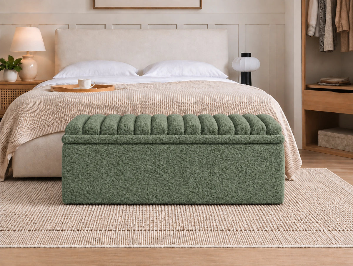Green channel tufted upholstered ottoman at the foot of a bed