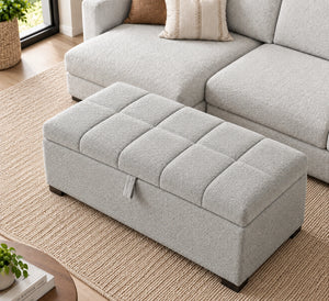 Light grey upholstered storage ottoman with tufted cushion top
