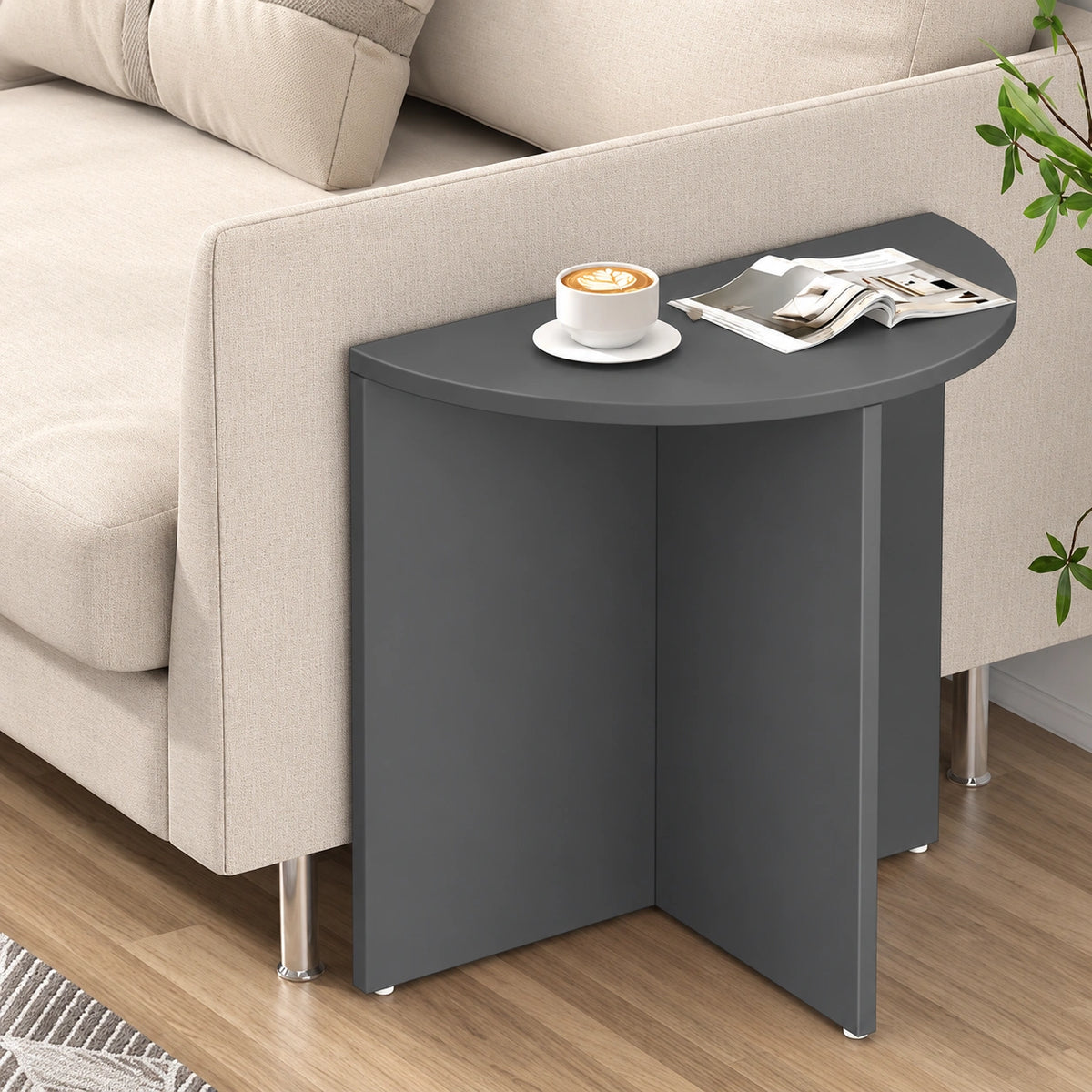 Modern charcoal half moon end table beside sofa
