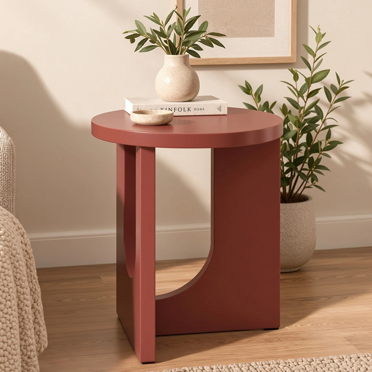 Modern terracotta round end table with curved base