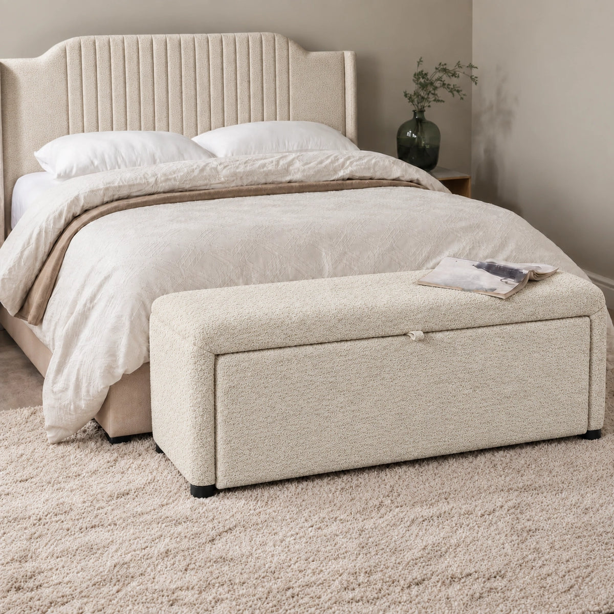 Off-white upholstered ottoman bench with storage in modern bedroom