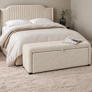 Off-white upholstered ottoman bench with storage in modern bedroom