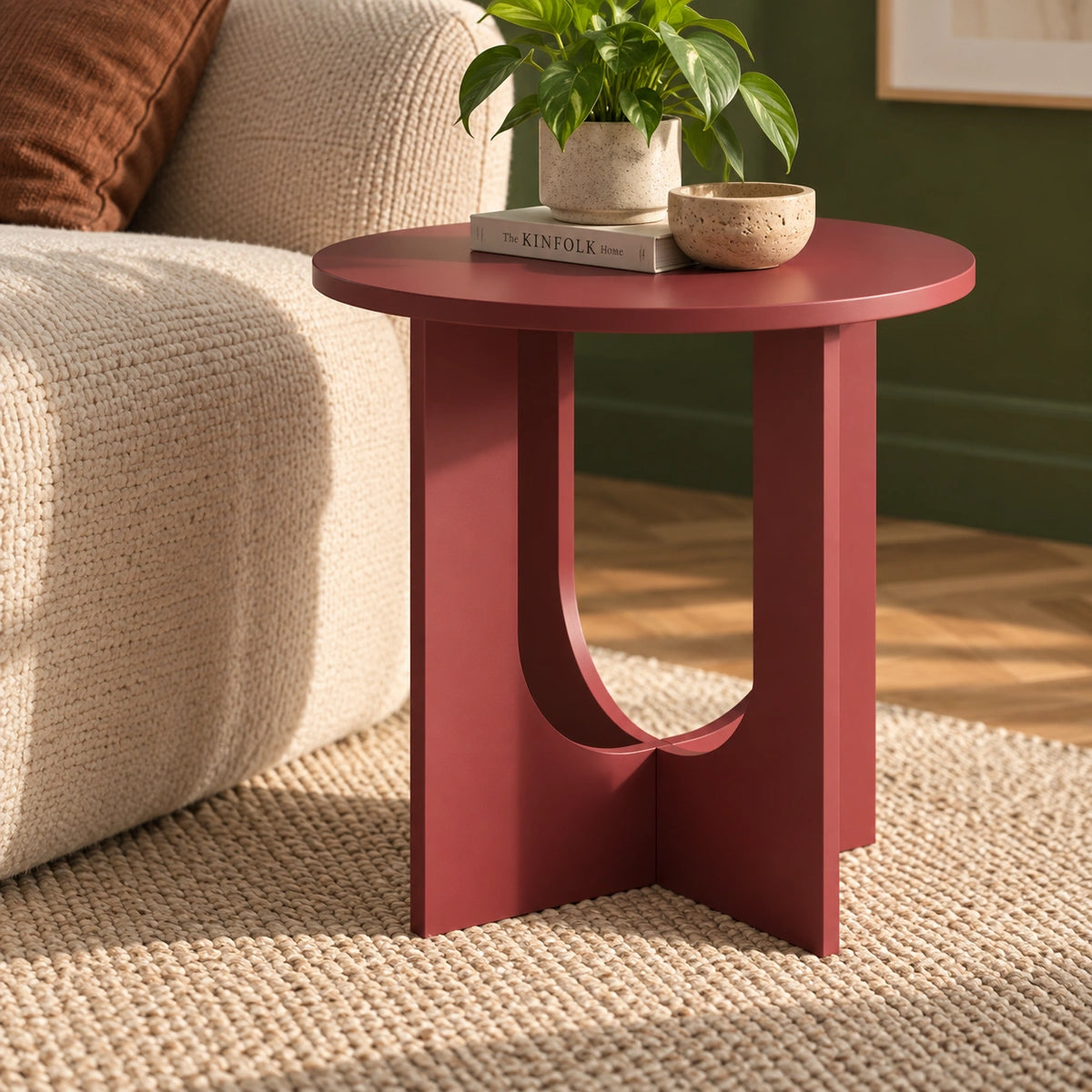 Round maroon end table in living room