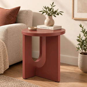 Terracotta round end table styled beside a modern sofa