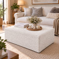 White upholstered storage ottoman